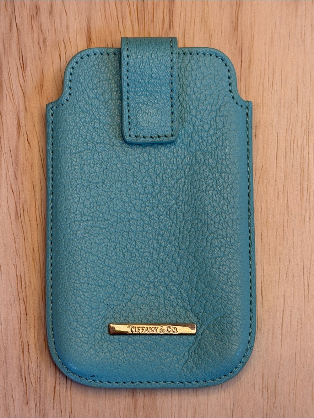 Tiffany & Co. turquoise pebbled leather phone sleeve with gold logo